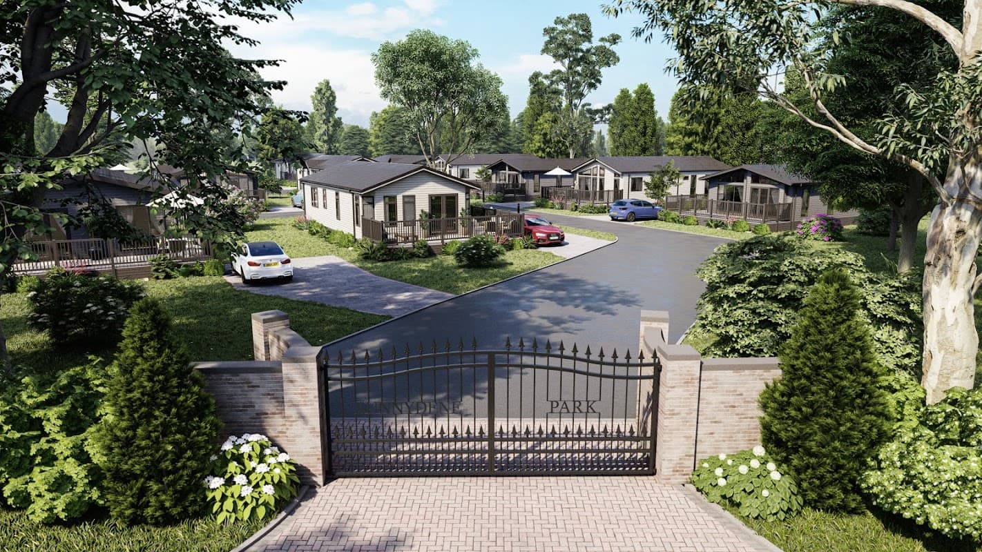 Gated entrance to Sunnydene Country Park, featuring modern lodges, landscaped greenery, and parked cars along a winding road.
