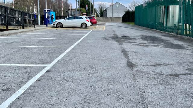 Free parking area at Dodworth Station, featuring several empty spaces and a few parked cars against a clear sky.