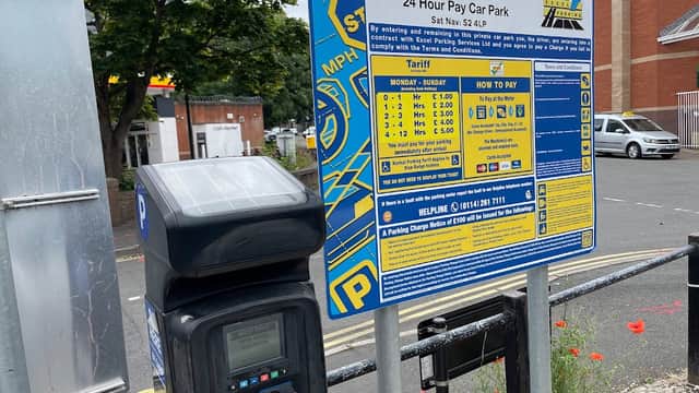 Beeley Street Car Park sign with parking fees, payment instructions, and a pay station in Sheffield, Yorkshire.