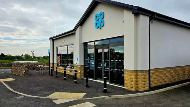 Co-op Food store with large windows, blue signage, and bike racks outside, set in a rural area of Bramhope, Yorkshire.