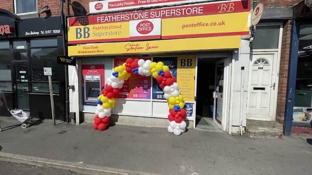 Featherstone Post Office with a colorful balloon arch at the entrance and a bright red and yellow sign above.