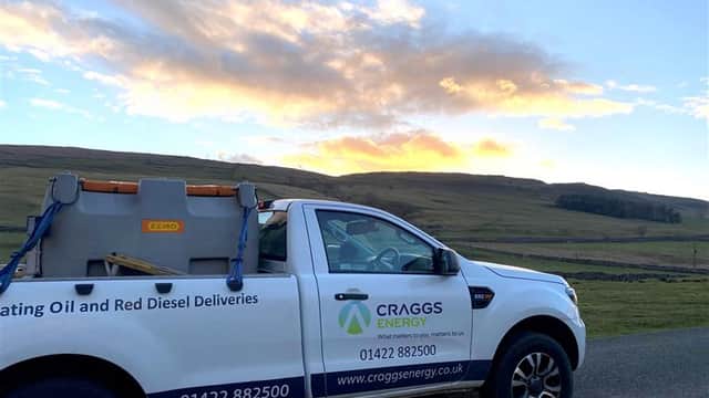 Craggs Energy Ltd truck parked on a rural road with a scenic sunset and hills in the background.