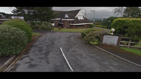 A winding road leads to a modern building surrounded by greenery in West Vale, Yorkshire.