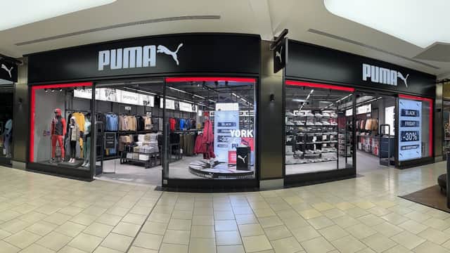 PUMA Outlet in York featuring sportswear, shoes, and promotional signage in a modern retail setting.