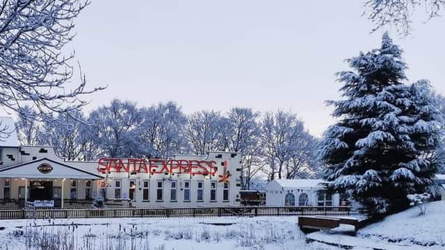 Whistlestop Valley cafe with snow-covered trees and a "Santa Express" sign in a winter landscape.