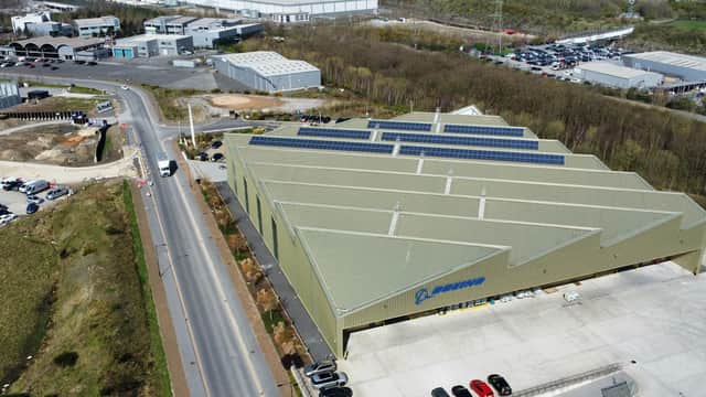 Aerial view of Boeing Car Park in Carbrook, featuring a large building with solar panels and adjacent parking areas.