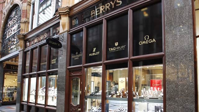 Elegant jewellers storefront featuring luxury brands like Hublot, TAG Heuer, and Omega in a historic arcade.