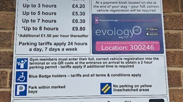 Parking sign detailing tariffs, payment methods, and terms at Frenchgate Rooftop Car Park in Doncaster, Yorkshire.