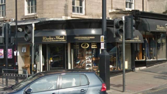 Rhodes-Wood shoe shop exterior in Harrogate, featuring a sign with "Christopher Forbes" and parked car in front.