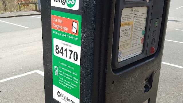 Pay & Display parking meter with instructions for mobile payment via RingGo, located in a parking area.