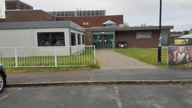 Modern building with large windows, green grass, and a pathway leading to the entrance of Ryedale Swim and Fitness Centre.