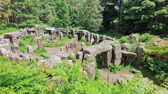 Ancient stone circle surrounded by lush greenery and ferns at Hill Top Farm in Ilton, Yorkshire.