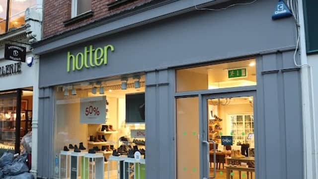 Hotter Shoes store exterior in York, featuring a large window display and a bold green sign above the entrance.