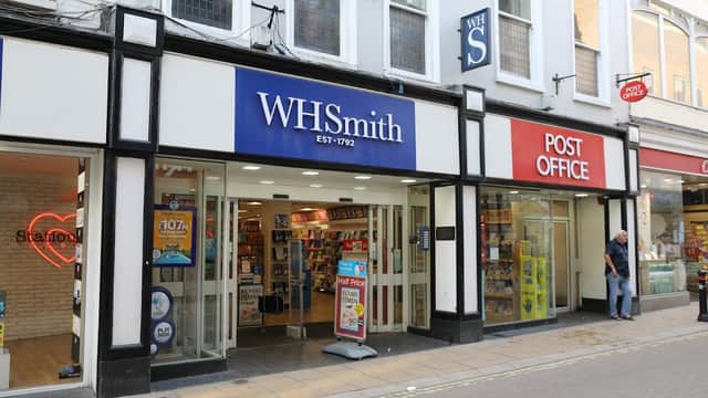 WHSmith store with blue signage and Post Office nearby, both located on a pedestrian street in Harrogate, Yorkshire.