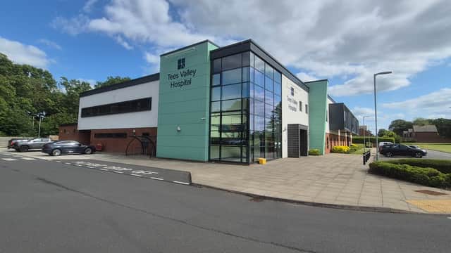 Modern building with large glass windows, "Tees Valley Hospital" sign, and landscaped surroundings in Tees Valley, Yorkshire.