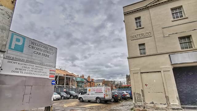 Crown Street Car Park sign, cloudy sky, parked vehicles, and nearby buildings in Leeds, Yorkshire.