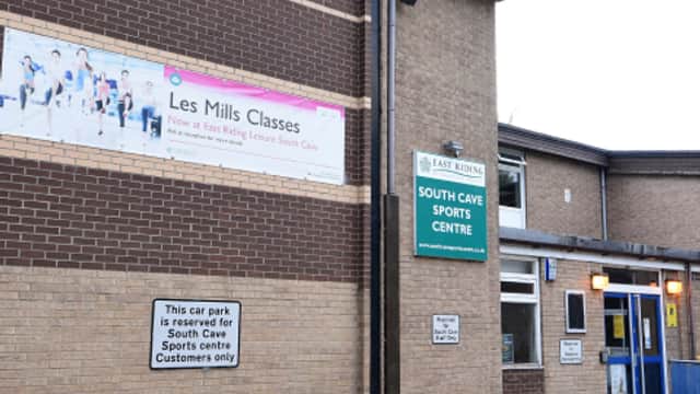 Exterior view of East Riding Leisure South Cave, featuring a sign for Les Mills classes and a reserved parking notice.