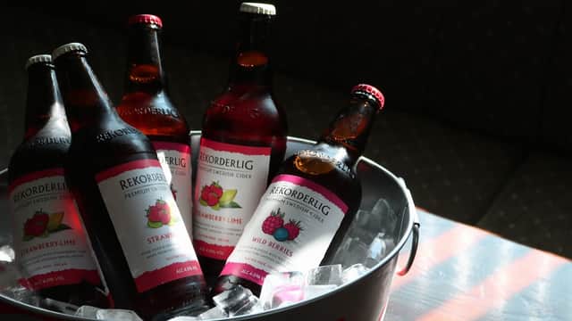 Five bottles of Rekorderlig cider in a bucket of ice, featuring strawberry-lime and wild berries flavors.