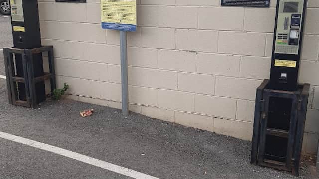 Pay and display parking machines next to signage in a car park in Huddersfield, Yorkshire.