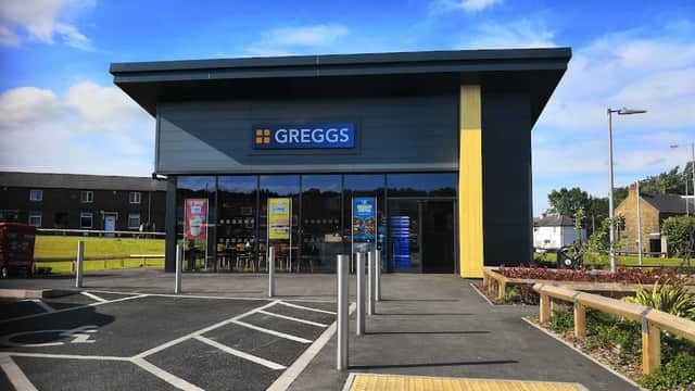 Greggs shop in Clayton, Yorkshire, featuring a modern facade, signage, and outdoor seating area.