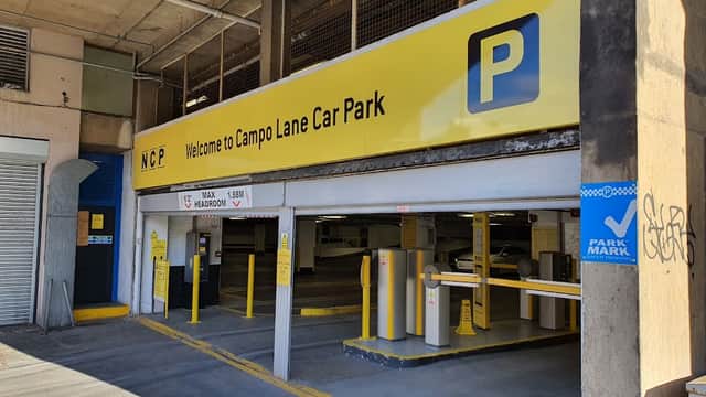 Welcome sign for Campo Lane Car Park with yellow background, parking symbols, and entrance barriers.