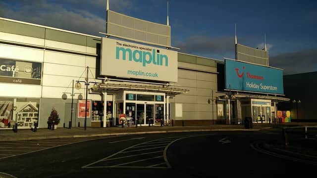 Maplin and Thomson Holiday Superstore storefronts at Parkgate Shopping Park, with clear blue skies above.