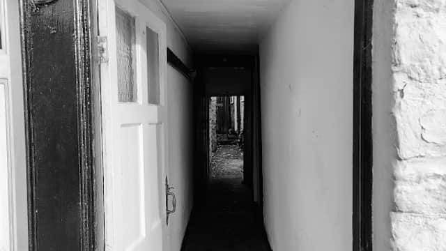 Entrance to Birch Hall Inn with a "Public Bar" sign and a narrow corridor leading inside.