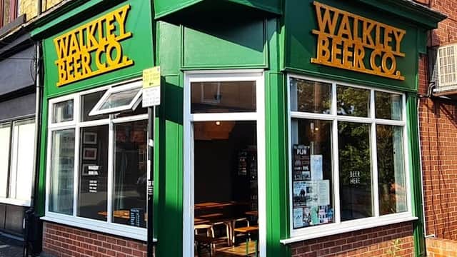 Green storefront of Walkley Beer Co. with large yellow signage, featuring windows and a welcoming entrance.