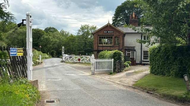 Quaint hotel with a sign reading "New Bridge," surrounded by greenery and a quiet road in Newton-upon-Rawcliffe.