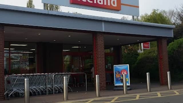 Iceland supermarket entrance with shopping carts and a clear sign, located in Monk Bretton, Yorkshire.