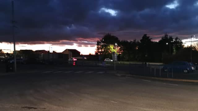 Dinnington Interchange at dusk, with dark clouds and a hint of sunset colors illuminating the surroundings.