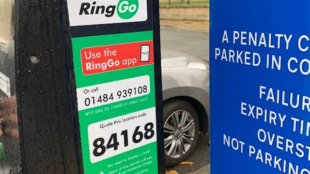 Parking payment station with RingGo instructions, a phone number, and a location code in Springwood Car Park, Huddersfield.