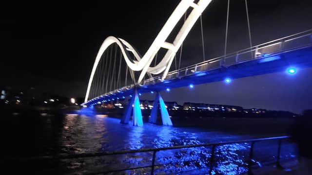 Illuminated bridge over water at night, with blue lights and dark sky, near Stockton-on-Tees Borough Council.