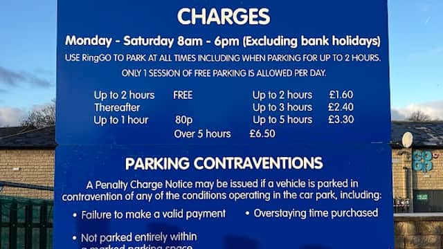 Sign for Station Road car park in Mirfield, detailing charges, rules, and RingGo parking information.
