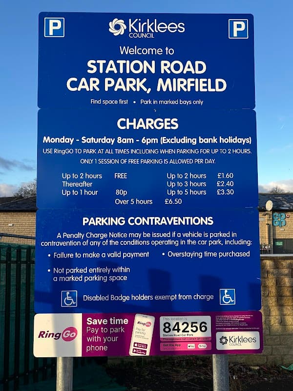 Sign for Station Road car park in Mirfield, detailing charges, rules, and RingGo parking information.