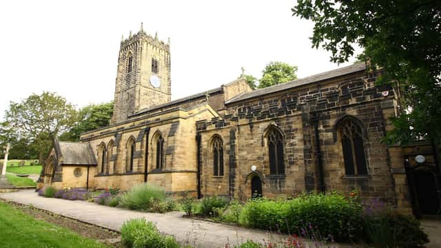 Thornhill Parish Church features a tall clock tower and stone facade, surrounded by green lawns and flowering plants.