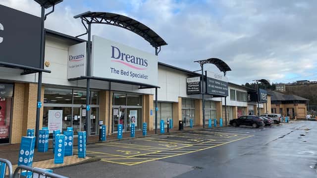 Dreams store front at Forster Square Shopping Park, with parking spaces and cloudy sky in the background.
