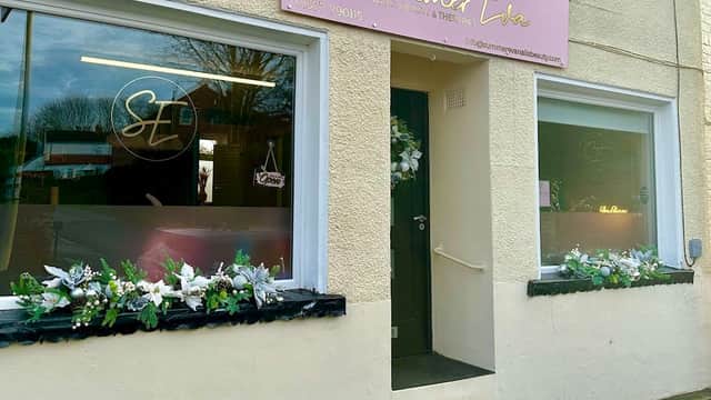 Exterior of Summer Eva salon in Nafferton, Yorkshire, featuring floral decorations and a pink sign above the entrance.