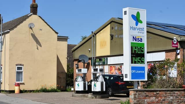 Grocers with a fuel station, signage for Harvest Energy and Nisa, and a residential building nearby in Burton Pidsea.