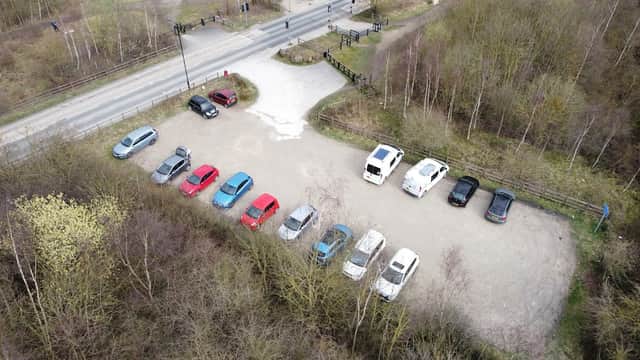 Aerial view of a car park with various parked cars surrounded by trees and a road in Wath upon Dearne, Yorkshire.