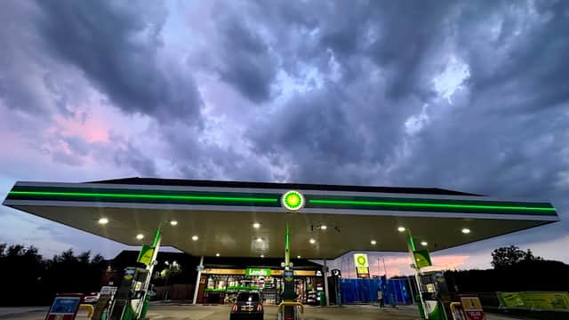 Bilbrough Top Services with a BP petrol station under a cloudy sky, featuring fuel pumps and a shop entrance.
