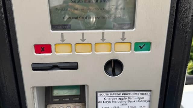 Mer Charging Station kiosk with payment buttons, a screen displaying instructions, and a card reader.