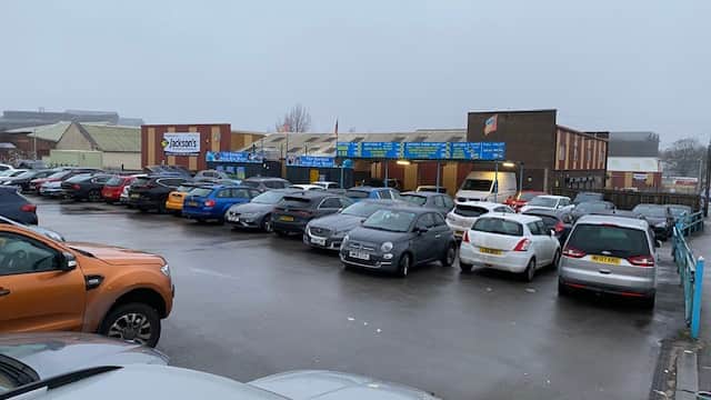 Pay & Display car park in Brightside, Yorkshire, featuring various parked cars and a cloudy, overcast sky.