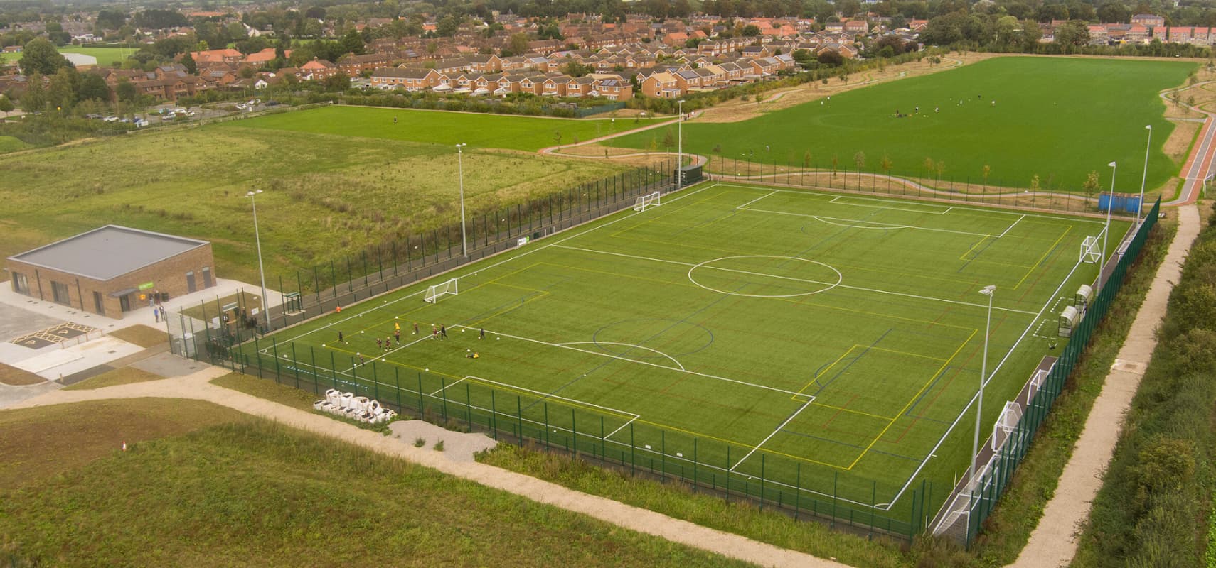 Aerial view of Thirsk Falcons FC's football pitch, surrounded by green fields and residential areas.