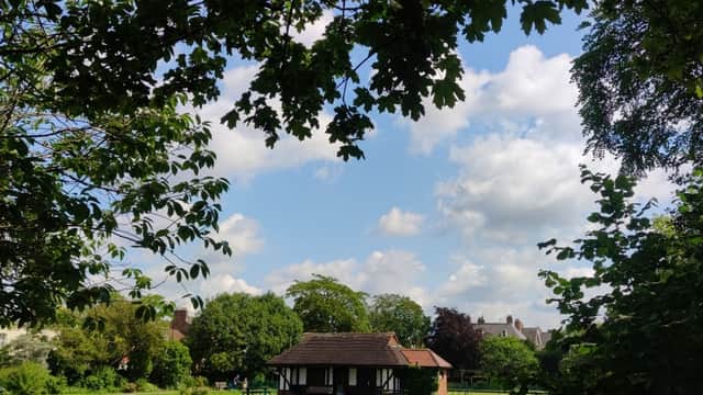 Glen Gardens building surrounded by lush greenery and trees under a partly cloudy sky in Heworth, Yorkshire.