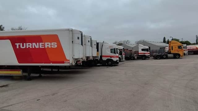 Trucks lined up in a car park with "Turners Ltd" branding, set against a cloudy sky in Ledston, Yorkshire.