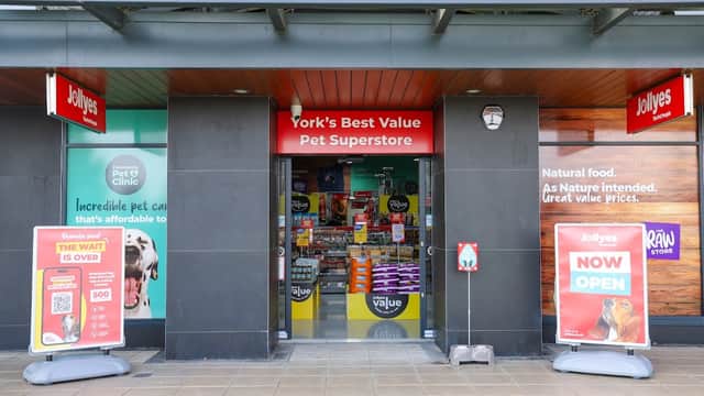 Entrance to Jollyes Pet Superstore in York, featuring bright signage, promotional banners, and pet supplies visible inside.