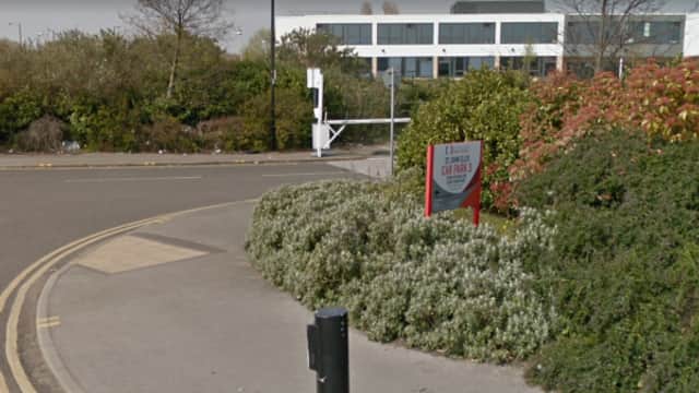 Pay & Display sign for YourParkingSpace, surrounded by greenery and a modern building in Doncaster, Yorkshire.