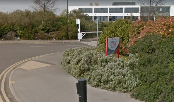 Pay & Display sign for YourParkingSpace, surrounded by greenery and a modern building in Doncaster, Yorkshire.