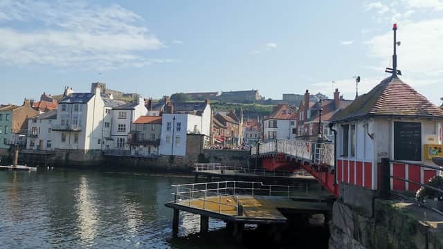 Cliff Street Car Park with waterfront views, colorful buildings, and a bridge in Whitby, Yorkshire.